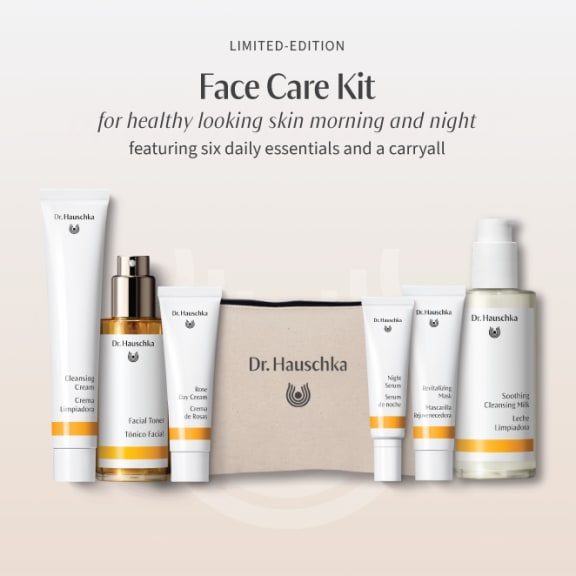Dr. Hauschka limited-edition face care kit with six skincare products and a beige carryall on a soft cream background.