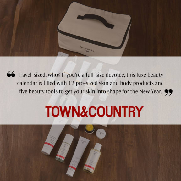 Town & Country promo image showing a Dr. Hauschka beauty advent calendar case with skincare products on a wooden floor.
