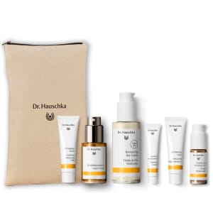 Dr. Hauschka gift set with beige zip pouch and six skincare products on a white background.