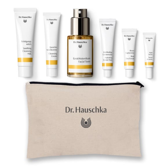 Dr. Hauschka skincare set with six products and a beige branded pouch on a white background.