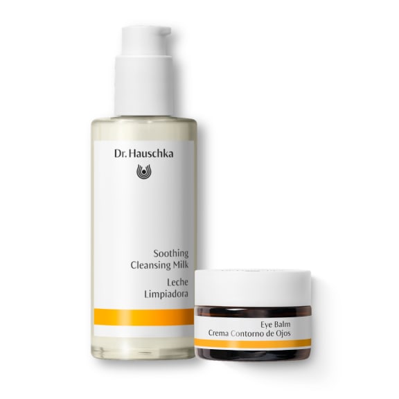Dr. Hauschka Soothing Cleansing Milk bottle and Eye Balm jar on a white background.