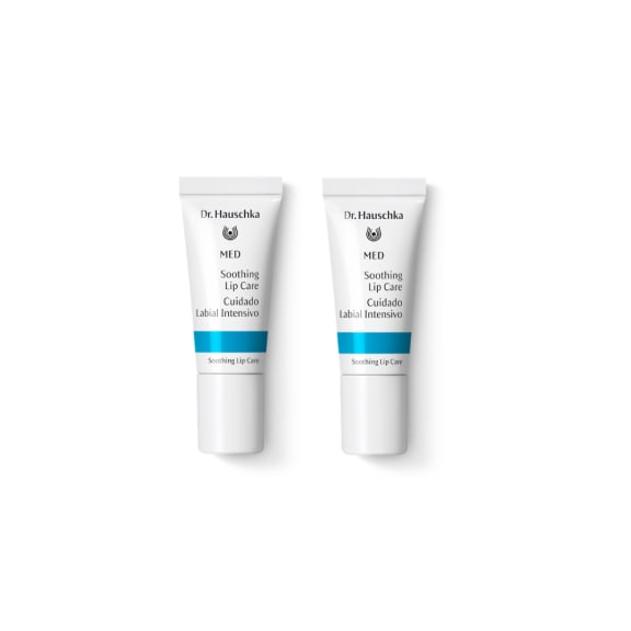 Two white Dr. Hauschka MED Soothing Lip Care tubes with blue bands on a plain white background.