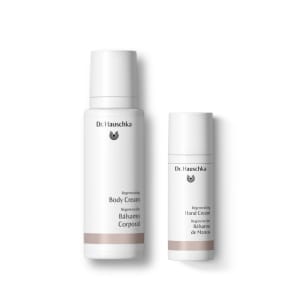 Two white Dr. Hauschka regenerating creams: body cream and hand cream bottles on a plain white background.