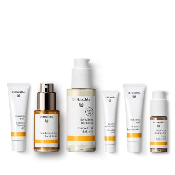 Dr. Hauschka skincare set of six products on a white background, including cleanser, toner, lotion, mask and tint.