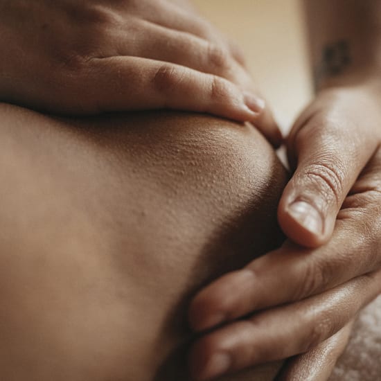 Close-up of hands gently massaging skin during a skincare routine.