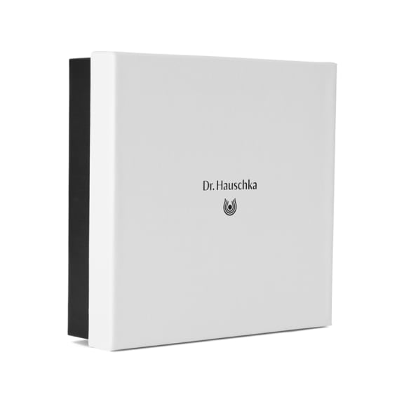 White Dr. Hauschka gift box with a black inner sleeve on a plain background.