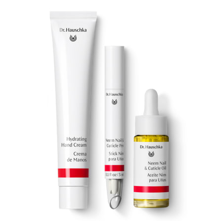 Dr. Hauschka hydrating hand cream, neem nail and cuticle pen, and nail oil displayed on a white background.