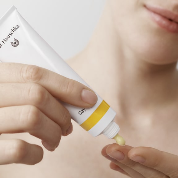 Woman applying day cream