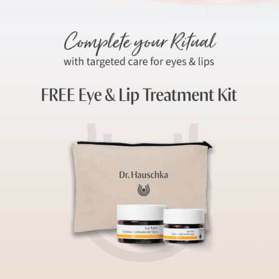 Promotional graphic for a free Dr. Hauschka Eye & Lip Treatment Kit with pouch, eye balm and lip balm.