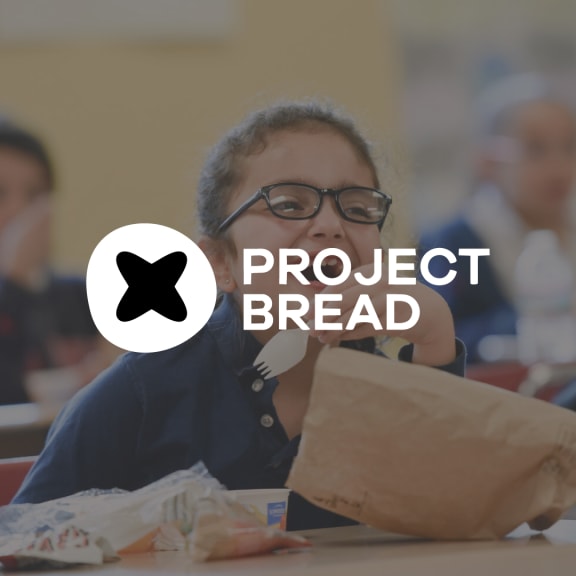 Project Bread logo over a blurred photo of a child at a table eating from a paper bag.