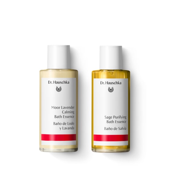 Two Dr. Hauschka bath essence bottles: Moor Lavender Calming and Sage Purifying, on a white background.