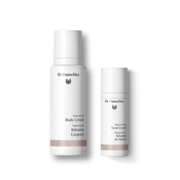 Two white Dr. Hauschka regenerating creams: body cream and hand cream bottles on a plain white background.
