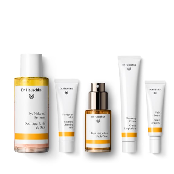 Five Dr. Hauschka skincare products on a white background, including cleanser, toner, eye makeup remover and night serum.
