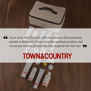 Town & Country promo image showing a Dr. Hauschka beauty advent calendar case with skincare products on a wooden floor.